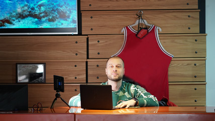 Young businessman working on a computer at the end of a working day