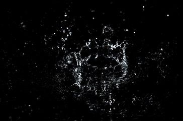 Splashes and drops of water are on a black background.