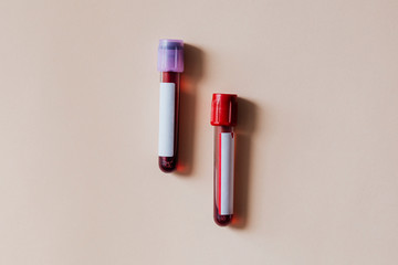 Blood test tubes on a beige background