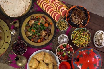Eid al-Fitr. Ramadan food on the table. The fast is broken with a feast at night called Iftar. Muslim family have a dinner at home together after evening prayers. Table setting top view