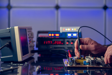 Debugging electronics device. PCB witch microcontroller in electronics laboratory