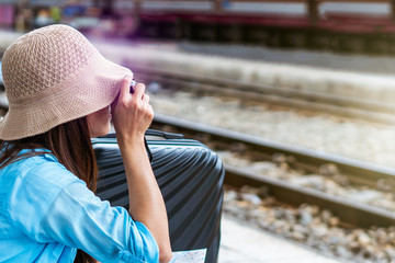 Solo woman backpacker traveler plan safety trip low cost budget summer holiday after coronavirus. Empty tourists on train railway platforms. Use bus train sustainable environmental friendly transport