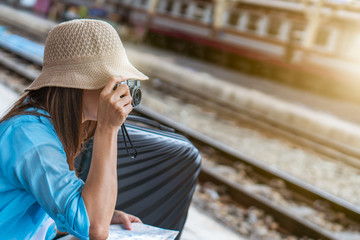 Solo woman backpacker traveler plan safety trip low cost budget summer holiday after coronavirus. Empty tourists on train railway platforms. Use bus train sustainable environmental friendly transport