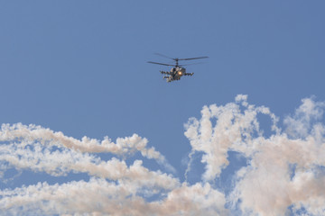 Fototapeta na wymiar Aerobatics on a Ka-52 Hokum B helicopter with the release of heat traps