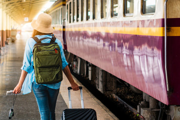 Solo woman backpacker traveler plan safety trip low cost budget summer holiday after coronavirus. Empty tourists on train railway platforms. Use bus train sustainable environmental friendly transport - obrazy, fototapety, plakaty