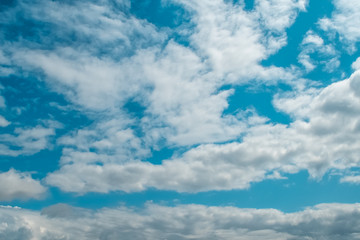Blue sky background with tiny clouds. Warm spring weather.