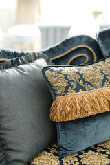 blue pillow with gold elements on the sofa