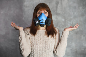 Panic and fear concept. Woman in respirator on dark background. Woman in respirator on dark...