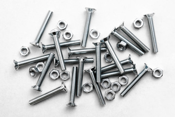 Top view of stainless steel bolts or iron nails on brigth white background with silver color. Metal screws for use in sheet metal.