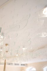 ceiling with glass transparent decorations in the form of waves