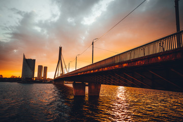 Fototapeta na wymiar Vansu bridge in Riga cable-stayed bridge crosses the Daugava river in susnet time