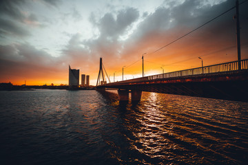 Fototapeta na wymiar Vansu bridge in Riga cable-stayed bridge crosses the Daugava river in susnet time
