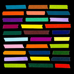 Collection of colorful adhesive tape pieces different size isolated on black background.

