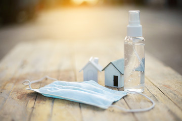 Alcohol gel and medical mask for hand cleaning to corona antivirus (covit-19), detention concept in the house