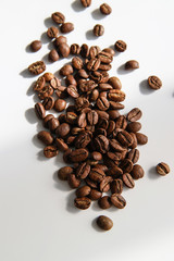 Coffee beans on white background. Trendy minimal caffeine and product for cheerfulness concept