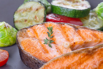 Two grilled salmon steaks with mix of vegetables