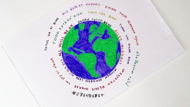 All will be ok in many languages and rotating world drawn on paper. Zoom in