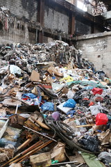 Large pile of garbage in an industrial building of a workshop