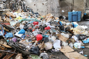 Large pile of garbage in an industrial building of a workshop