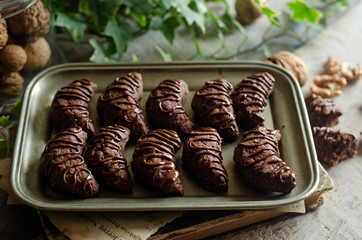 Peanut cookies with chocolate glaze on a rustic tray