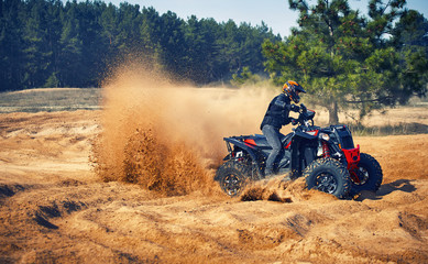 Racing in the sand on a four-wheel drive quad.