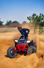 Racing in the sand on a four-wheel drive quad.