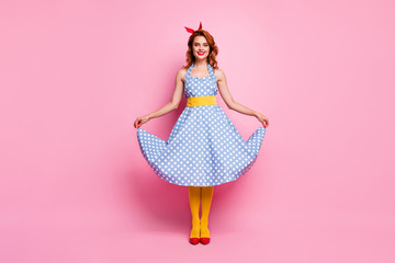 Full length photo of cheerful cute sweet fancy girl enjoy trend weekend touch polka-dot skirt outfit wear trend clothing isolated over pink color background
