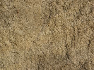 Orange stone texture picture with reliefs at sunset
