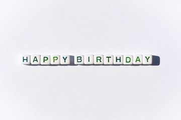 Happy Birthday postcard with cubes with green letters on white background