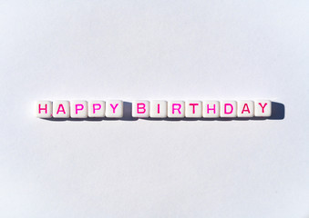 Happy Birthday postcard with cubes with pink letters on white background