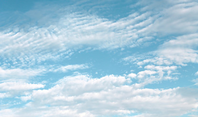 Clouds spread  patterns on bright blue sky background