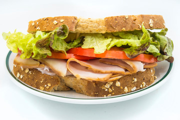 Sandwich of tomato, lettuce and smoked turkey