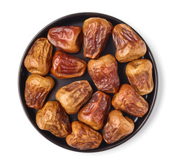 Dates on a black plate, isolated on white, from above