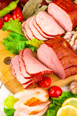 sausage meat with vegetables and herbs wooden background