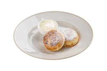 fried cottage cheese pancakes with sour cream isolated on white background