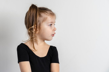 little European girl on a light background turned her head to the right to copy space.