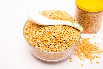 Toor dal or split yellow lentils in a glass bowl isolated