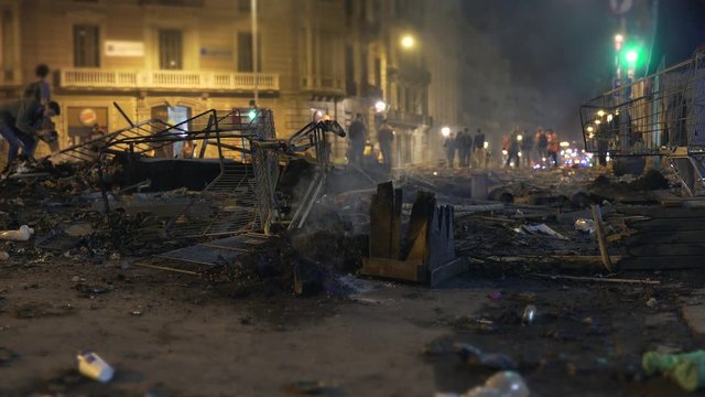 Burning bins and destruction after the clash between young revolutionary groups and the police in the streets