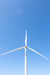 Beautiful green meadow with Wind turbines and sky  generating electricity in Thailand