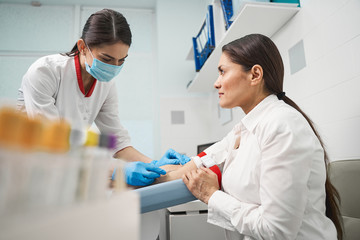 Attentive young woman looking at her doctor