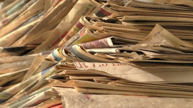 Old newspaper stack being shown from start to end