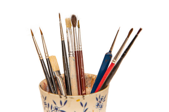 different paint brushes in a cup, isolated