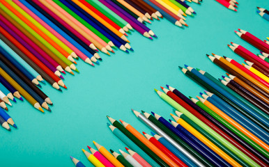 Color pencils on blue background. Back to school. Flat lay, layout