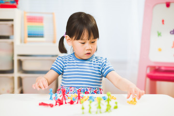 Fototapeta premium toddler girl learning counting and math for homeschooling