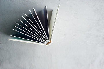 Photobook in hard leather cover on a gray concrete background. Making photos and storing them. A...