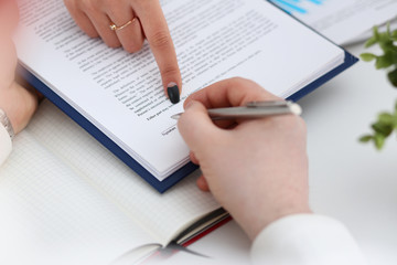 Arm fill and sign important form clipped to pad with silver pen closeup. Make note gesture read pact sale agent bank job loan credit mortgage investment finance chief legal law take part in campaign