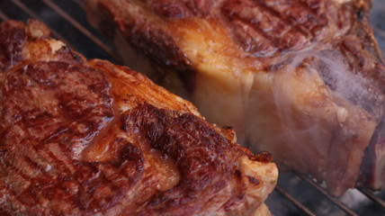 Obraz na płótnie Canvas Ribeye steak over the grill in the barbecue