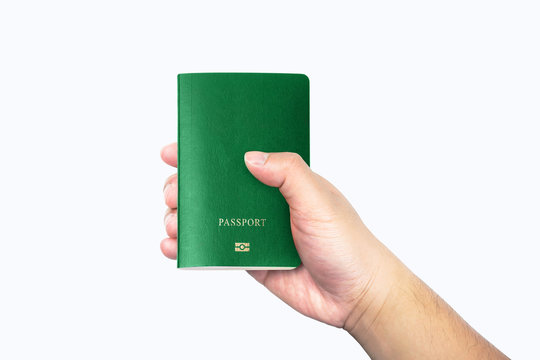 men hand holding blank green passport isolated on white background with clipping path