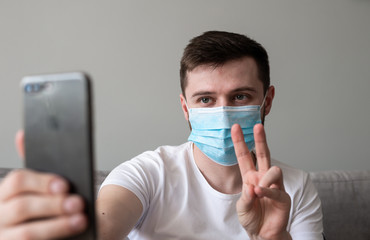 Fototapeta na wymiar COVID-19 Pandemic Coronavirus; Man wearing face mask protective for spreading of Coronavirus Disease and talking on mobile phone. Portrait of man with surgical mask on face against SARS-CoV-2.