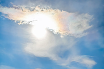 Naklejka na ściany i meble Sun peeked out from under cloud, blue sky.